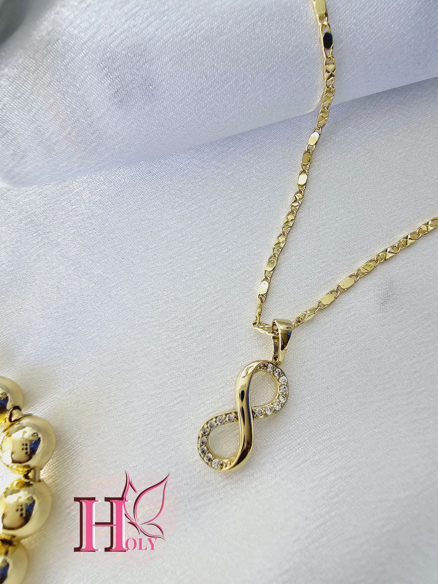 Dije Infinito Mini con pedreria oro laminado DI0017